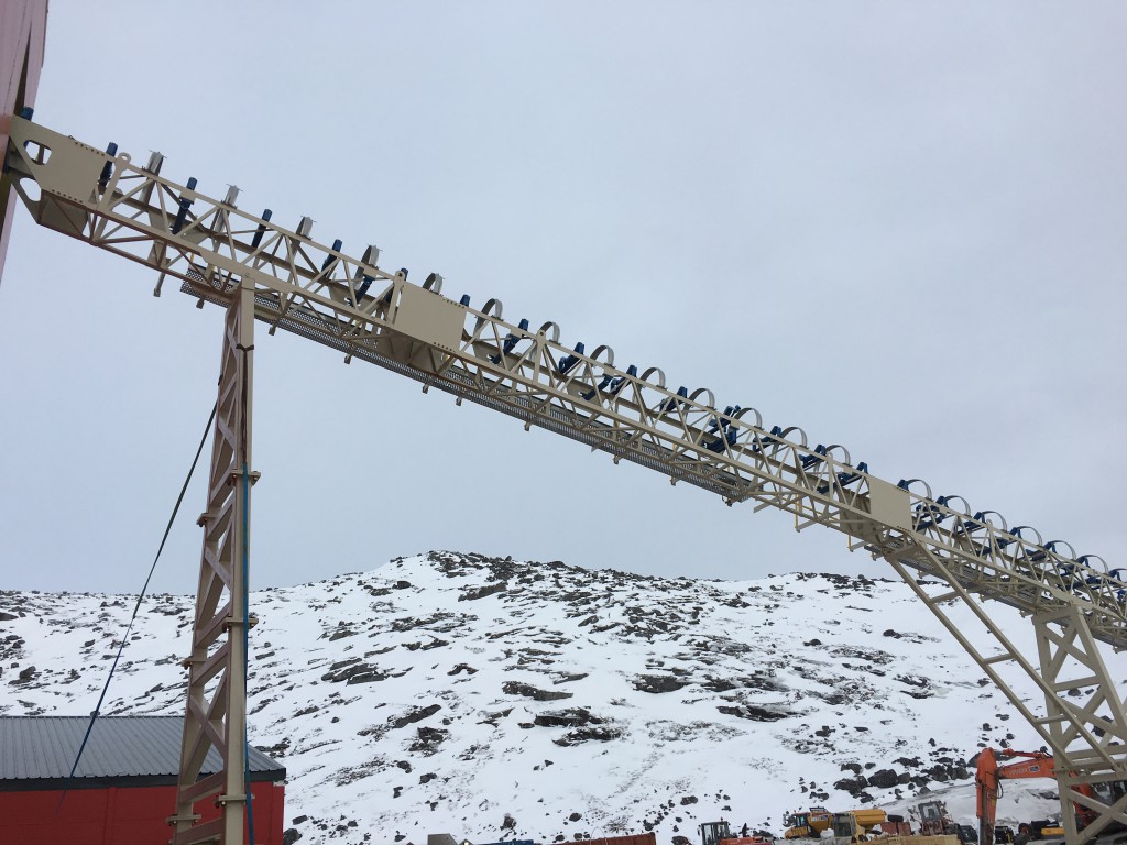 Exterior close-up of the primary ore conveyor entering Plant Building, Workshop building in background
